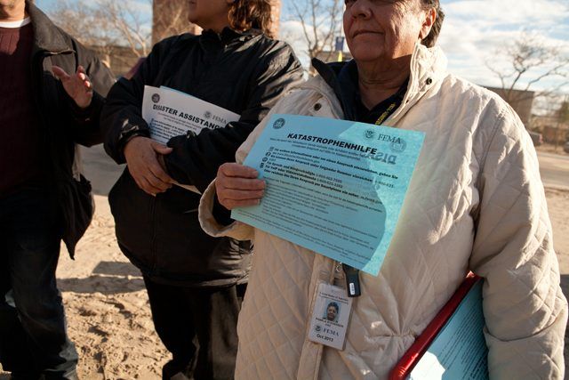 FEMA employees distribute information on how to make a claim